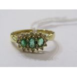 18ct YELLOW GOLD EMERALD & DIAMOND 3 STONE RING, 3 pricipal graduated oval cut emeralds surrounded