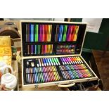 A fitted box containing numerous felt tip pens, crayons, pencils etc.