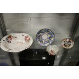 A Poole Pottery plate, a Dresden floral decorated bowl, an Imari style teapot stand and a floral