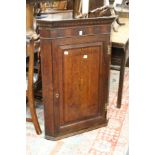 A George III oak hanging corner cupboard.