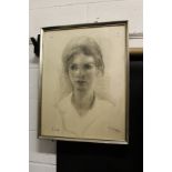 A portrait bust of a young girl, charcoal, signed.