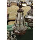 A decorative eastern style patinated metal hanging lantern.