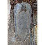 A large galvanized bath tub.