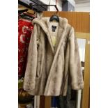 A good ladies' faux fur coat, appears unused.