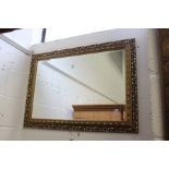 A decorative gilt framed mirror.