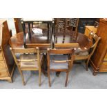 A George III design mahogany twin pillar extending dining table with two leaves.