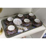 An eastern enamelled small tray with a set of six matching cups and saucers and a similar dish.