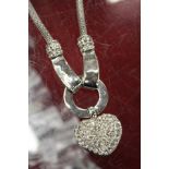 A decorative necklace with heart shaped diamante pendant.