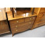 A George III mahogany chest of two short and two long drawers on splay bracket feet.