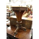 A 19th century rosewood octagonal shaped work table on carved tripod base.