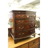 A George III style mahogany bow front four drawer chest with brushing slide.