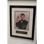 A signed photograph of Pierce Brosnan, framed and glazed.