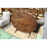 A continental pine oval tilt top dining table.
