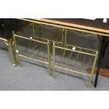 A pair of stylish brass framed two tier glass topped lamp tables.