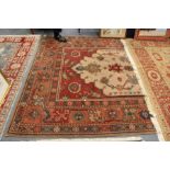 A large Persian style woollen carpet.