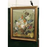 A good silk work embroidered picture depicting flowers in a vase on a ledge, in a gilt frame.