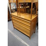 The matching teak four drawer chest.