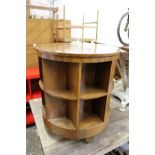 A walnut circular revolving table / bookcase.