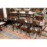 A good George III design mahogany triple pillar extending dining table with two leaves.