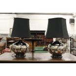 A stylish pair of large chrome plated table lamps with shades.