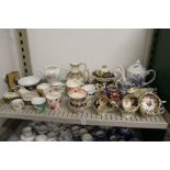 A shelf of decorative tea ware etc.