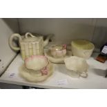 A Belleek porcelain faux bamboo teapot and other Belleek porcelain.