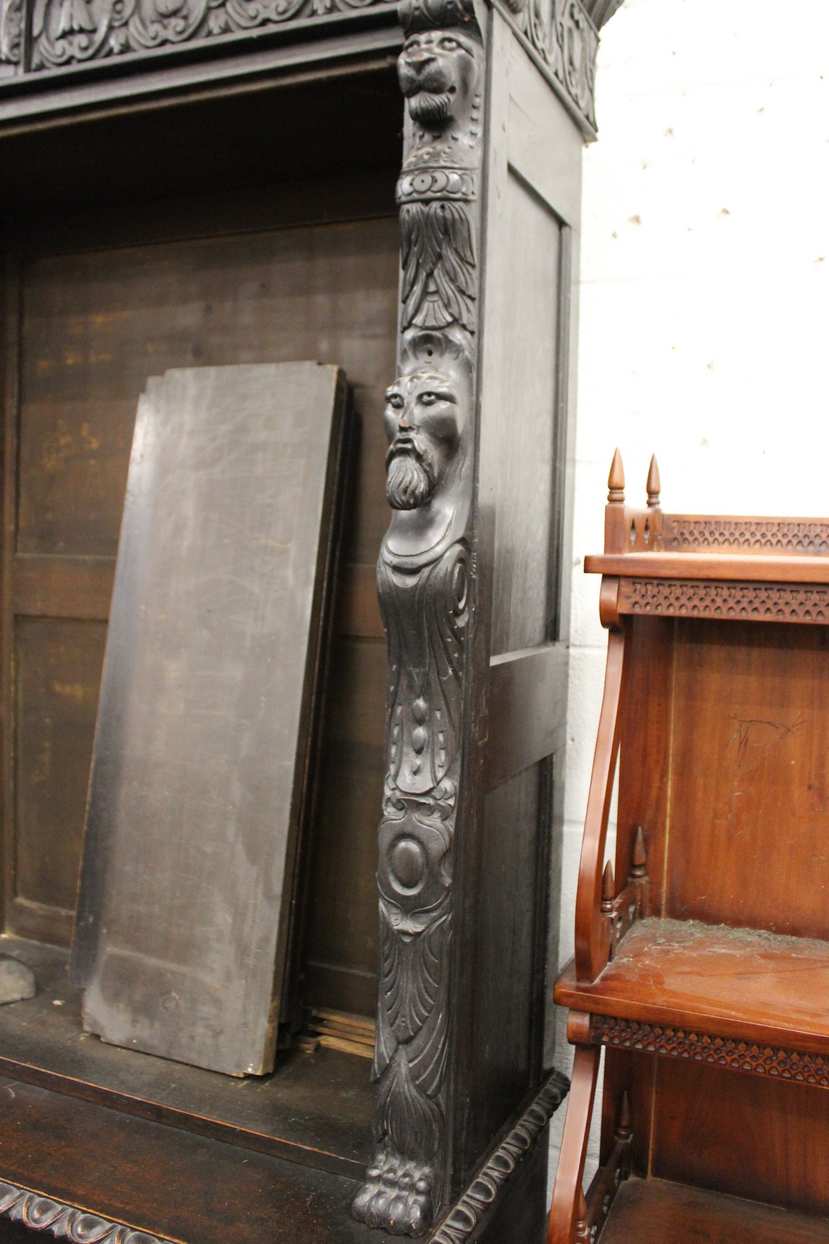 A late Victorian Gothic Revival carved oak cupboard bookcase. - Image 2 of 3