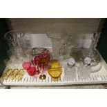 A pair of cut glass decanters with metal mounts possibly silver together with cut glass vases and