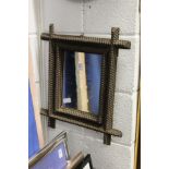 An unusual small mirror with carved frame.