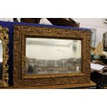 A gilt framed mirror.