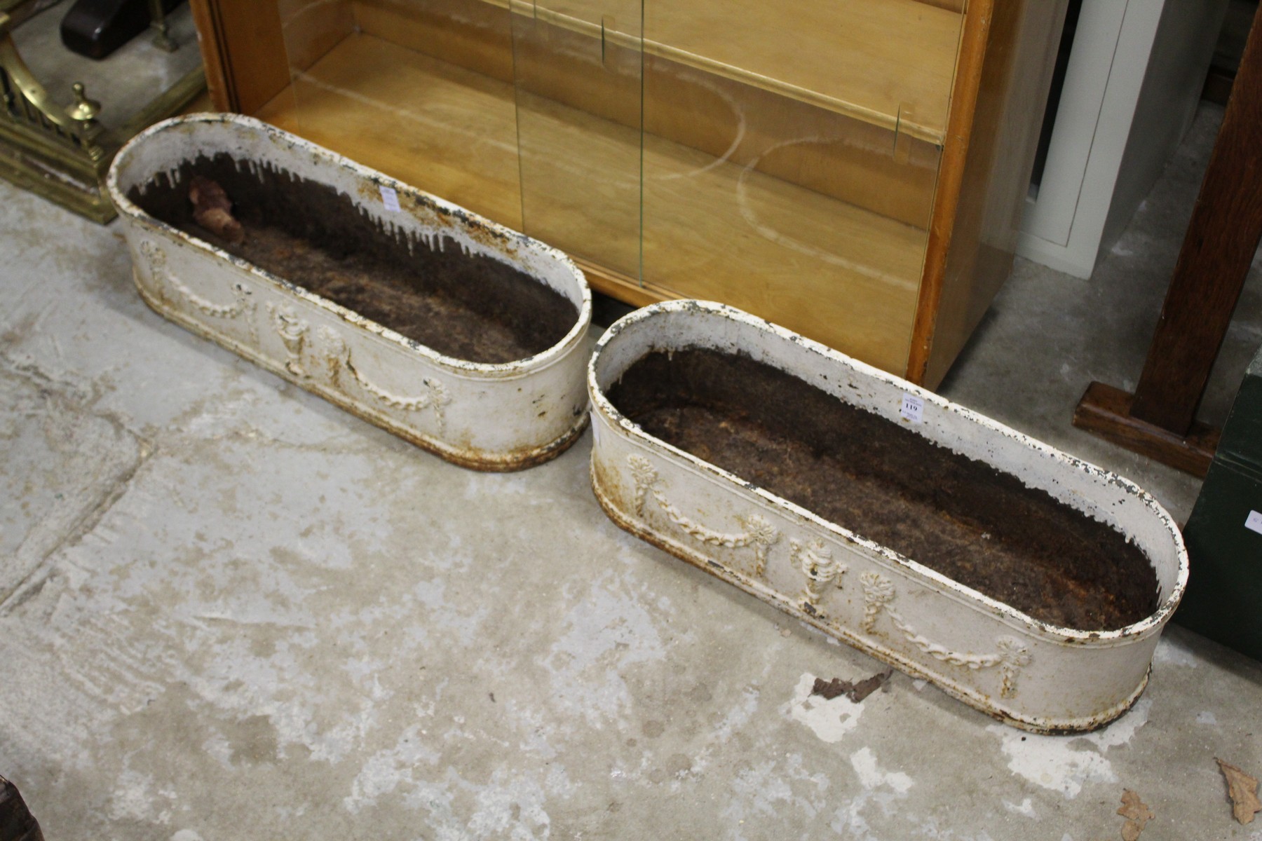 A pair of painted cast iron garden troughs.