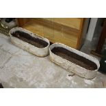 A pair of painted cast iron garden troughs.