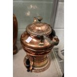 A copper kettle on stand.