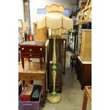 A decoratively painted floor standing lamp with ornate shade and another shade.