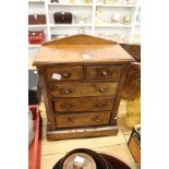 A Victorian walnut miniature chest of drawers.