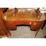 A walnut kidney shaped dressing table.