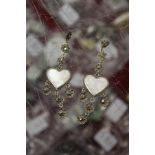 A pair of heart shaped earrings.