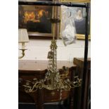 A decorative eight branch brass and cut glass chandelier (AF).