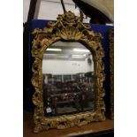 A gilt framed mirror.