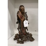 A Chinese lacquer figure of a sage.