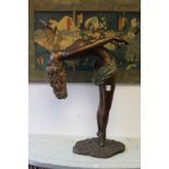A bronze coloured resin sculpture of a female diver.