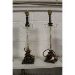 A pair of cut glass and metal lamp bases.