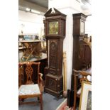An 18th century long case clock with square brass dial and carved oak case (alterations).