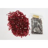 A small bag of red coloured gemstones.