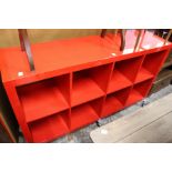 A stylish red lacquer eight division storage trolley.