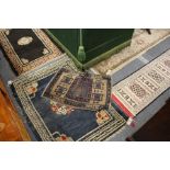 Four small Persian style rugs.