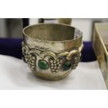 An unusual circular plated metal bowl with inset cabochon stones.