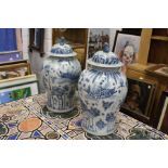 A large pair of Chinese blue and white temple jars and covers.