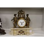 A French gilt metal and alabaster mantle clock.