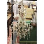 A large decorative cut glass eight branch chandelier.